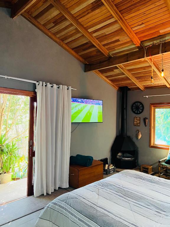 Uma TV ou centro de entretenimento em Quarto/suíte com lareira