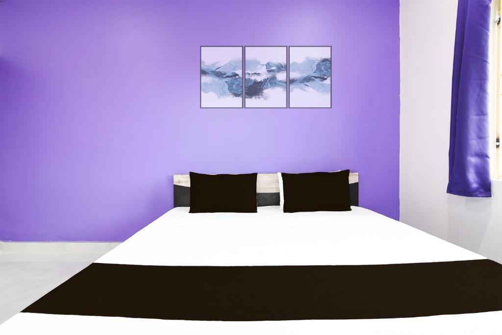 Postel nebo postele na pokoji v ubytování Super Hotel O MNJ Mansion