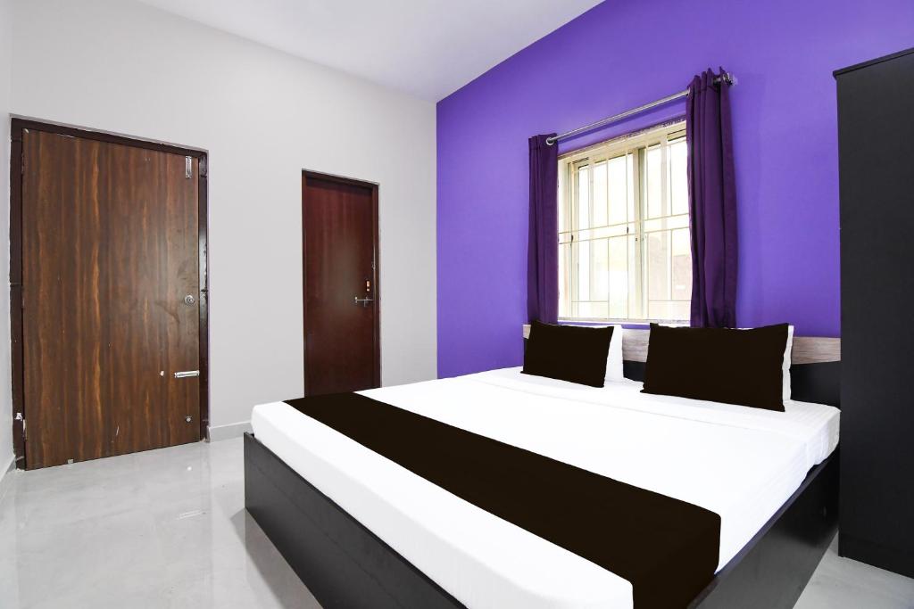 Postel nebo postele na pokoji v ubytování Super Hotel O MNJ Mansion