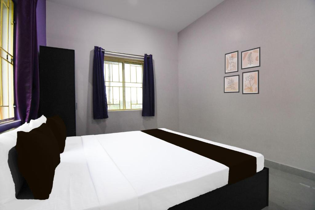 Postel nebo postele na pokoji v ubytování Super Hotel O MNJ Mansion