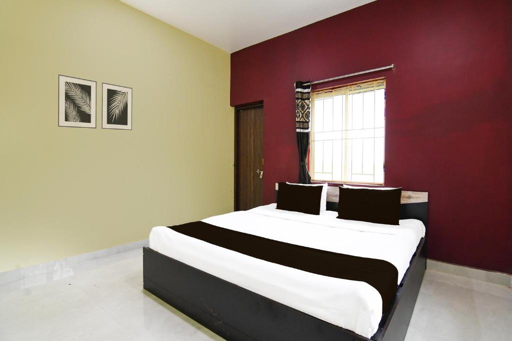 Postel nebo postele na pokoji v ubytování Super Hotel O MNJ Mansion