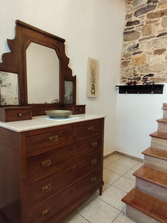 a bathroom with a sink and a mirror on a dresser at Mastiha house in Neochórion