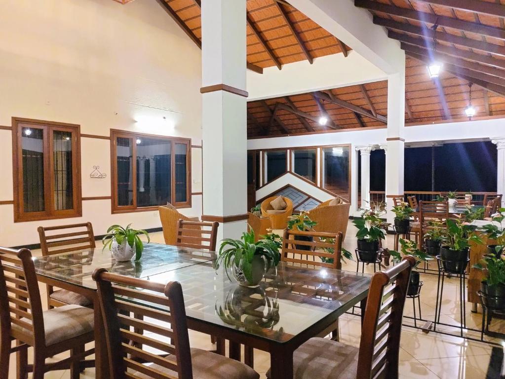 a dining room with a table and chairs at The Cana's Coorg in Ammatti