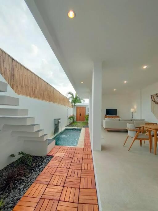 a living room with a staircase leading to a house at FREE airport pickup for new 2BR villa near Canggu in Sangeh