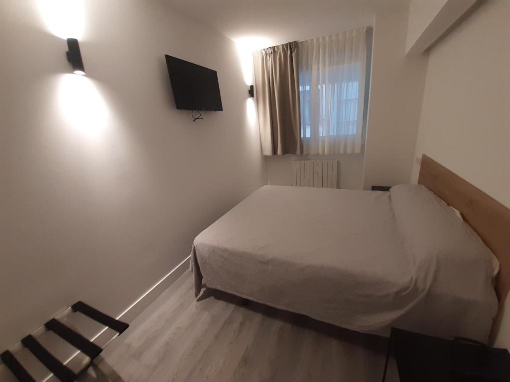 Postel nebo postele na pokoji v ubytování Hotel Photo Zabalburu
