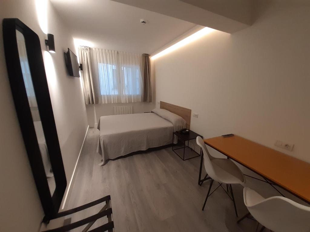 Postel nebo postele na pokoji v ubytování Hotel Photo Zabalburu