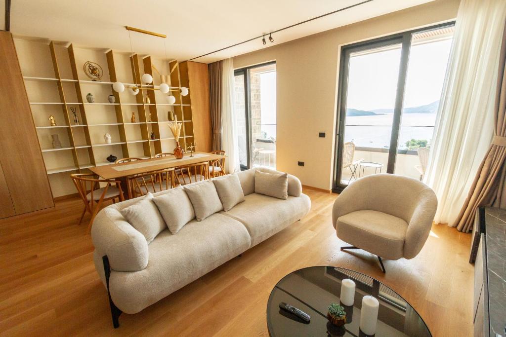 a living room with a couch and a chair at Regent Resort Budva in Budva
