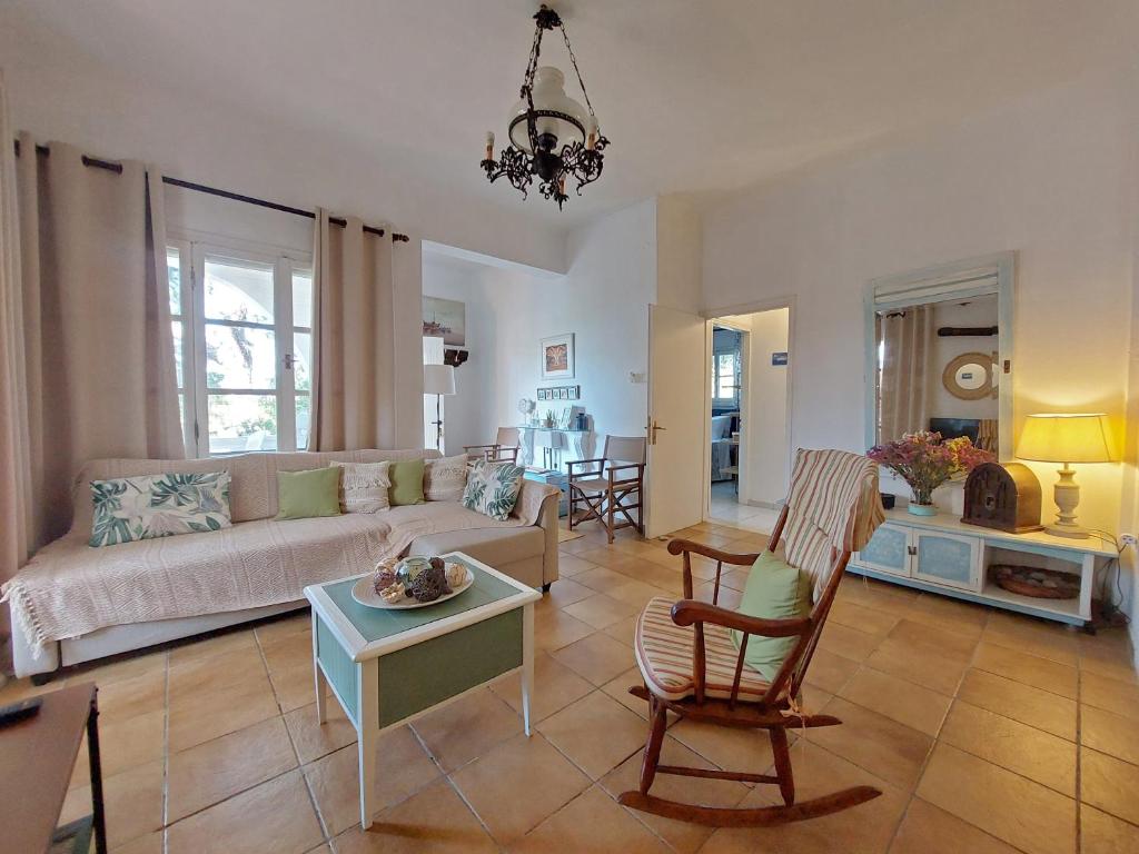 a living room with a couch and a table at Poros Pine View in Poros