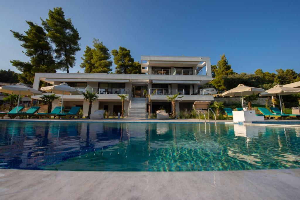 a large house with a swimming pool in front of it at Casa de Lapel Mola Kaliva in Mola Kalyva