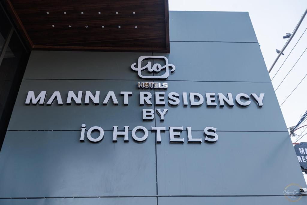 a sign for a man apartment residence by hotels at Mannat Residency By iO Hotels Near Golden Temple in Amritsar