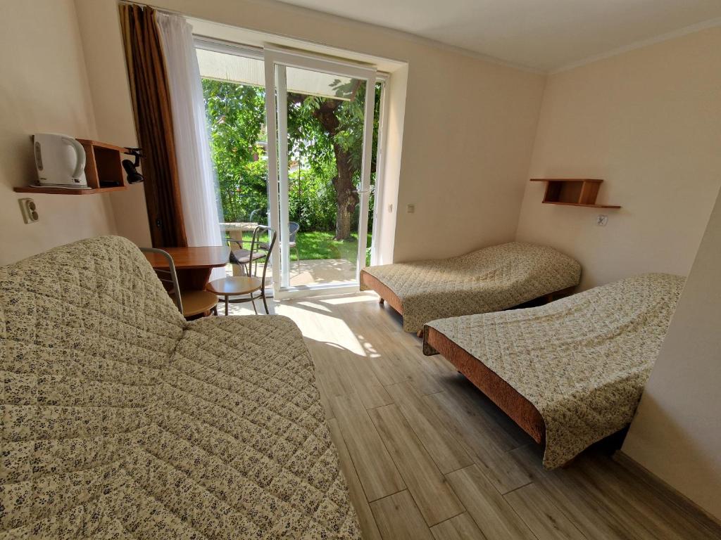 a living room with two couches and a window at Emides in Pobierowo