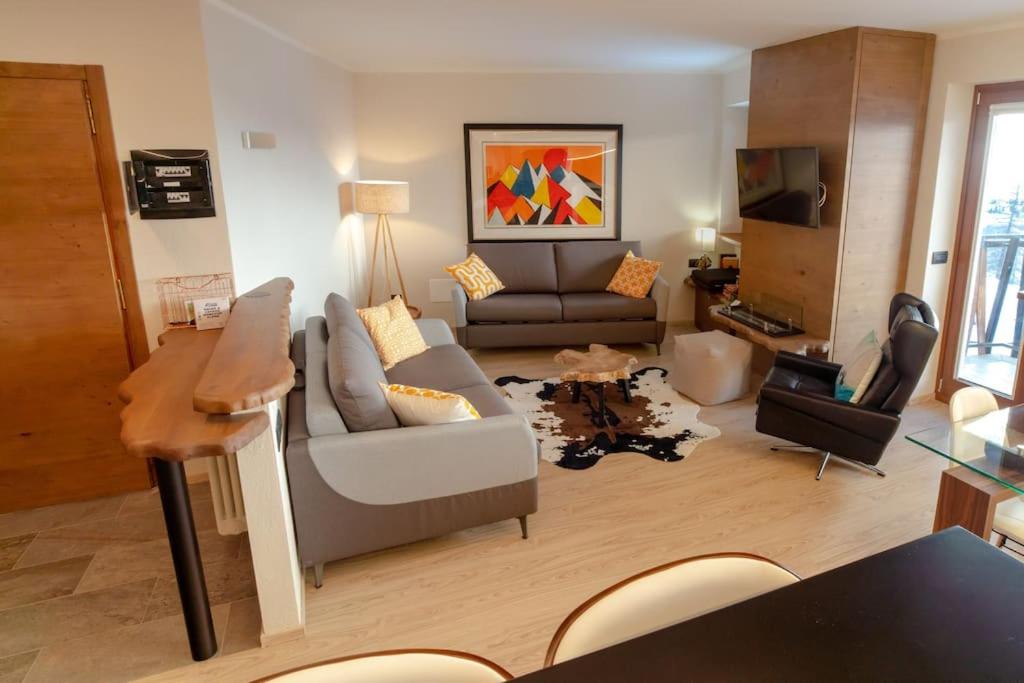 a living room with a couch and a table at Luxury flat in Cervinia 34 in Breuil-Cervinia