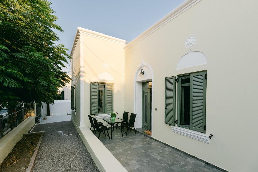 a patio with chairs and a table on the side of a building at Evgenia's House in Ampavris