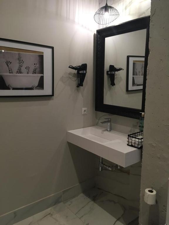 a bathroom with a sink and a mirror at Hacienda Soto-Hego Haizea in Chiclana de la Frontera
