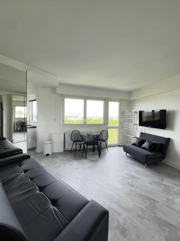a living room with a couch and a table at Apartment HOME in Paris with View, 15min to center in Paris