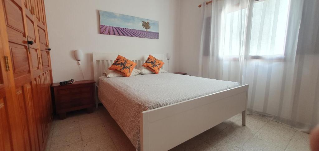 a small bedroom with a bed and a window at Casa maria in Puerto del Rosario