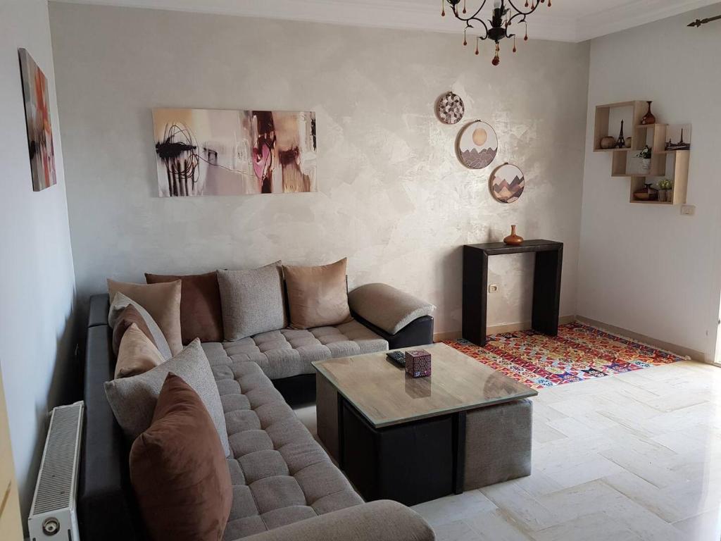 a living room with a couch and a coffee table at Nice apartment with nice view in El Aouina