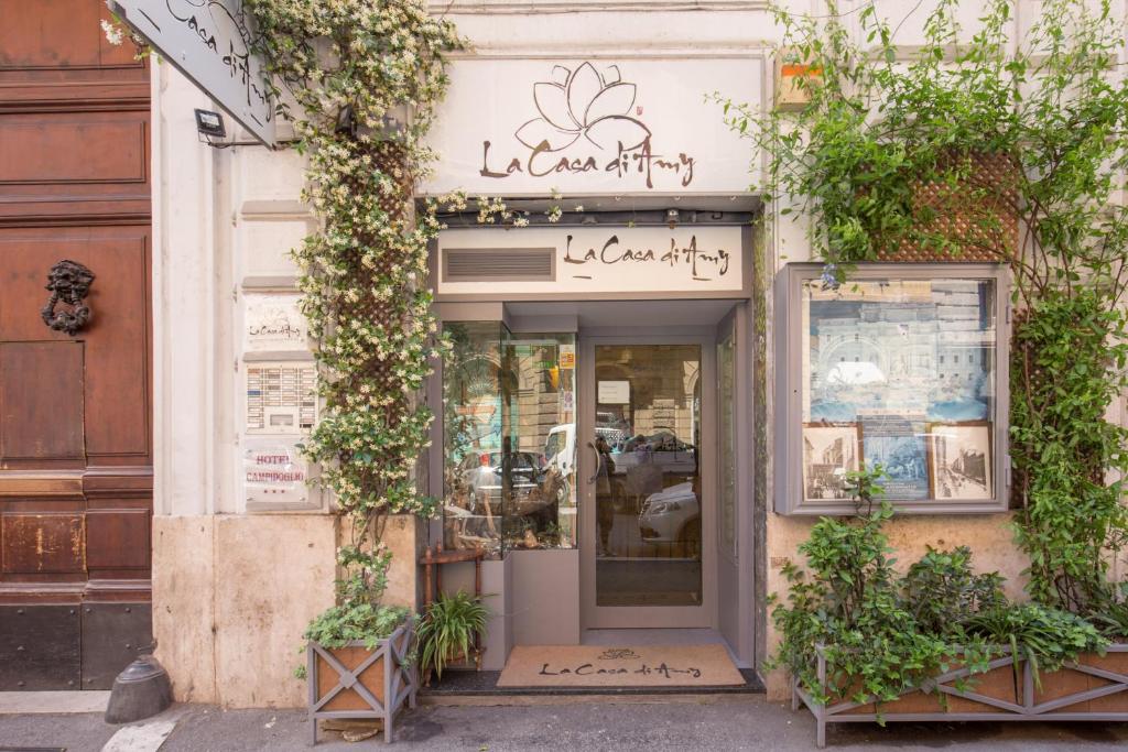 a store front with plants growing around it at La Casa Di Amy in Rome