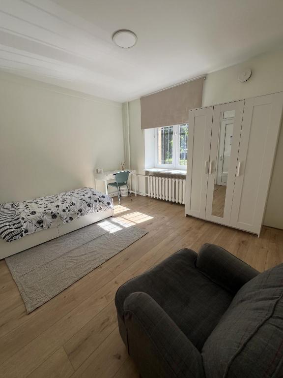 a living room with a bed and a couch at Peaceful Room in Shared Flat Close to Old Town in Tallinn