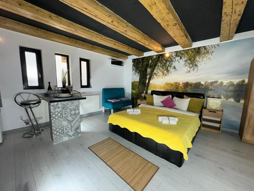 a bedroom with a large yellow bed and a desk at Smart Studio free parking in Craiova