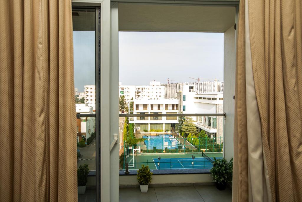a view of a pool from a window in a building at VRR Astoria Hotel & Convention Center in Bangalore