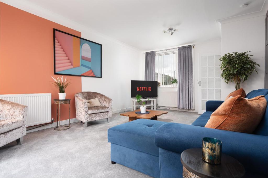 a living room with a blue couch and chairs at Cheshire Retreat, close to Tatton Park in Knutsford