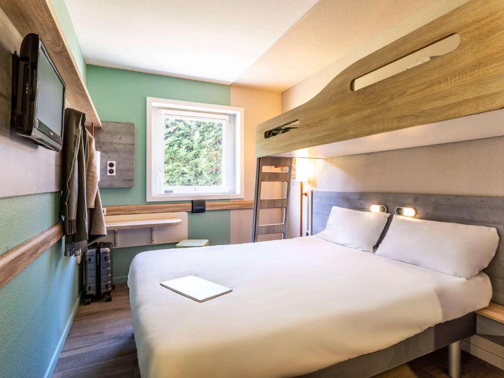 Postel nebo postele na pokoji v ubytování Ibis Budget Lyon Est Saint Quentin Fallavier