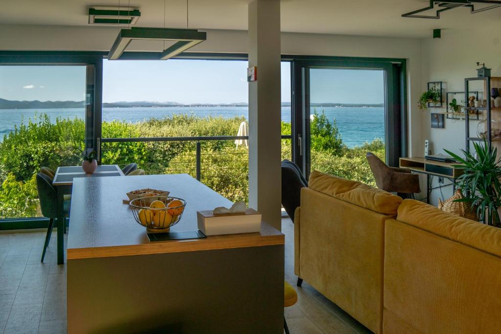 a living room with a couch and a table at Apartman Fjaka in Petrcane