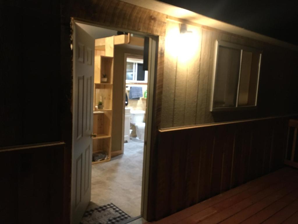 a room with a hallway with a light on the wall at New cabin 1 car rental available in Custer
