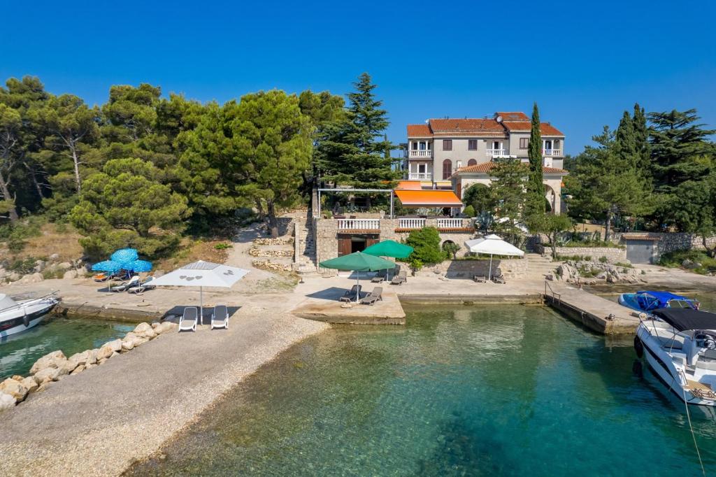 an aerial view of a house with a pool of water at APARTMENTS JADRANKa in Omišalj