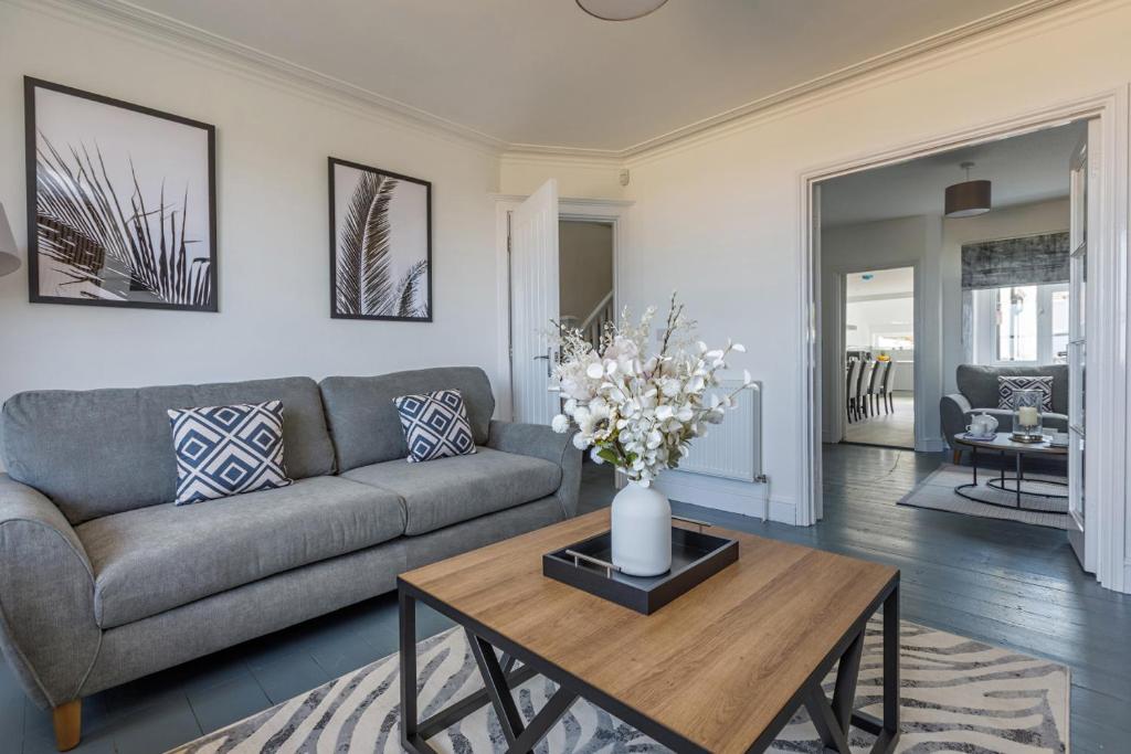 a living room with a couch and a table at Seaview at No.5 Mundesley in Mundesley