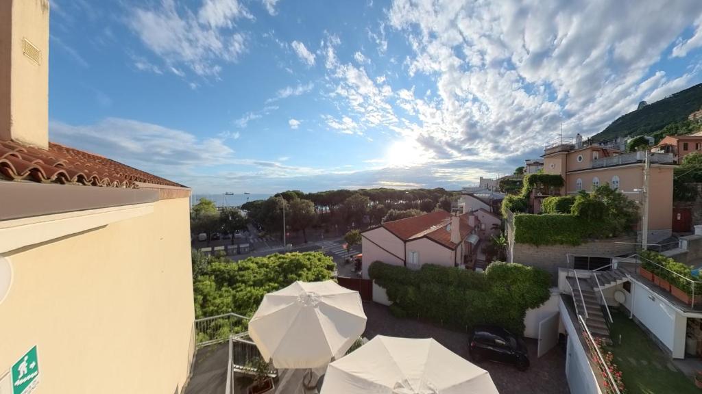 a view from the balcony of a building with umbrellas at Hotel Tritone in Trieste