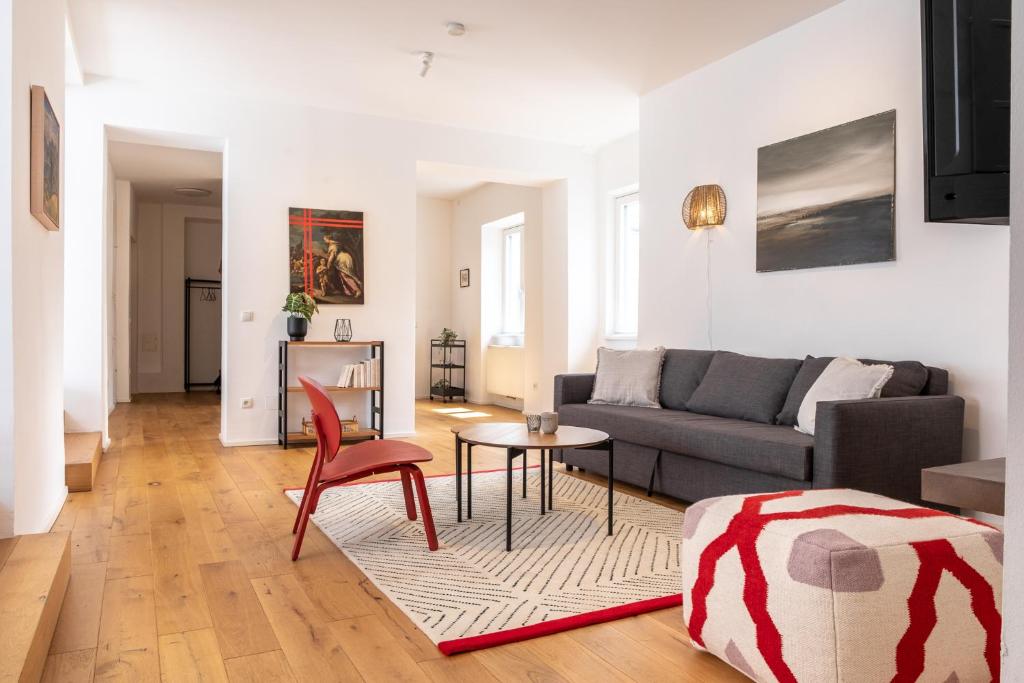 a living room with a couch and a table at Luxury Stay in City Center with terrace in Graz
