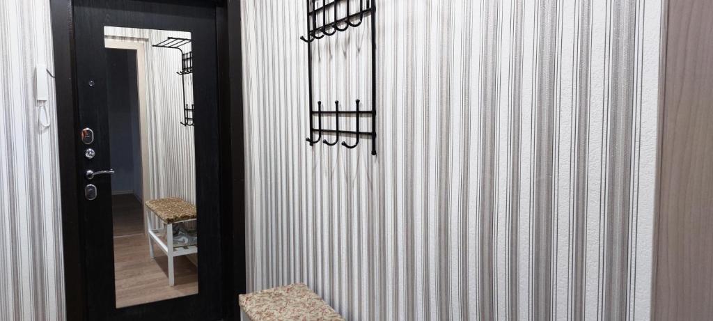 a door leading to a hallway with striped walls at 2-комнатная Комфорт на Сабитовой in Balqash