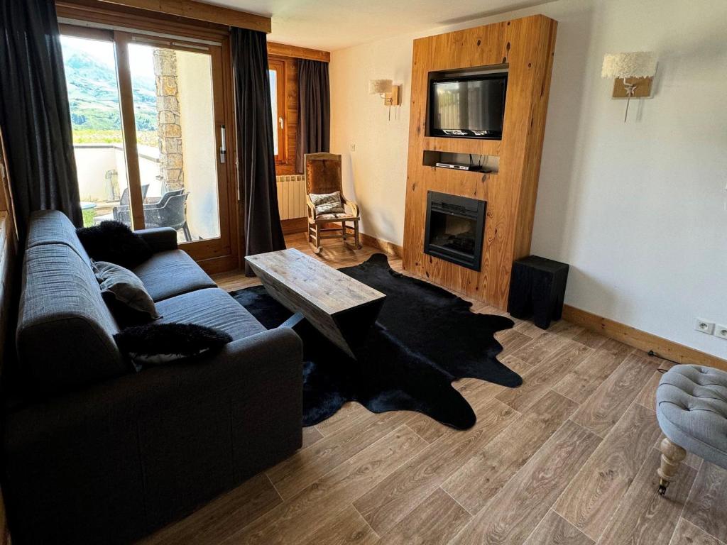 un salon avec un canapé et une table dans l'établissement Bel appartement 4 pièces avec piscine, jacuzzi, sauna, animaux admis - FR-1-181-2818, à La Plagne Tarentaise