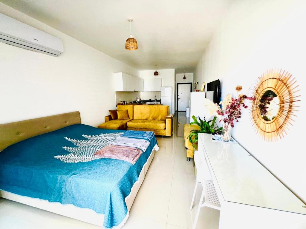 a bedroom with a bed and a living room at Studio Alev POOLview-CaesarResortSpa(North Cyprus) in Perivolia tou Trikomou