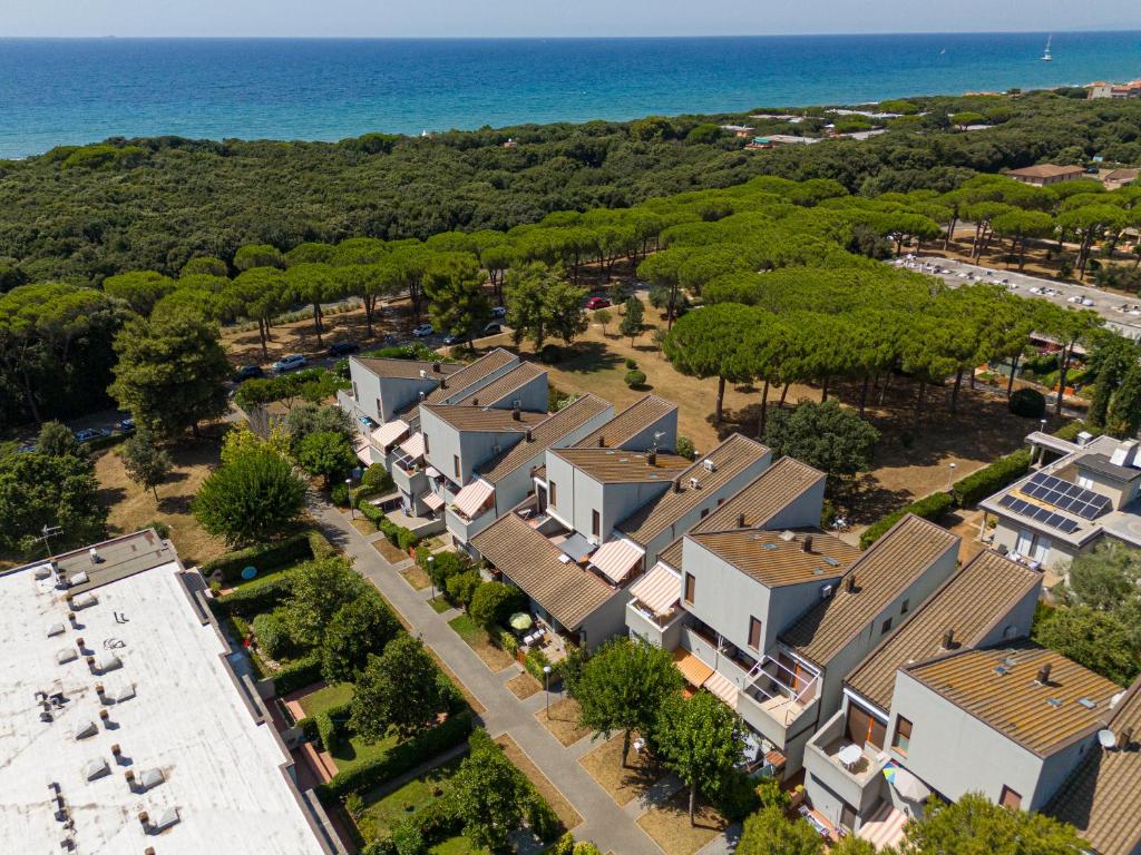 an aerial view of a residential estate with the ocean at San Vincenzo San Luigi 261 in San Vincenzo