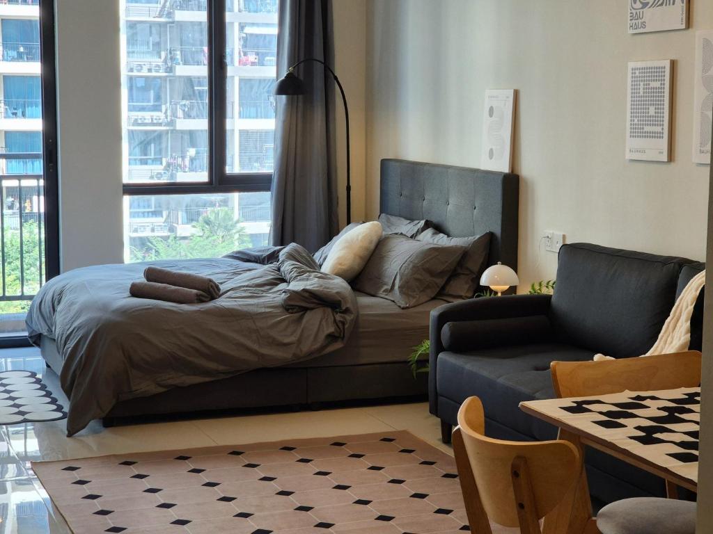 a bedroom with a bed and a couch at Central Park Cozy Garden View Studio for 3 pax in Johor Bahru