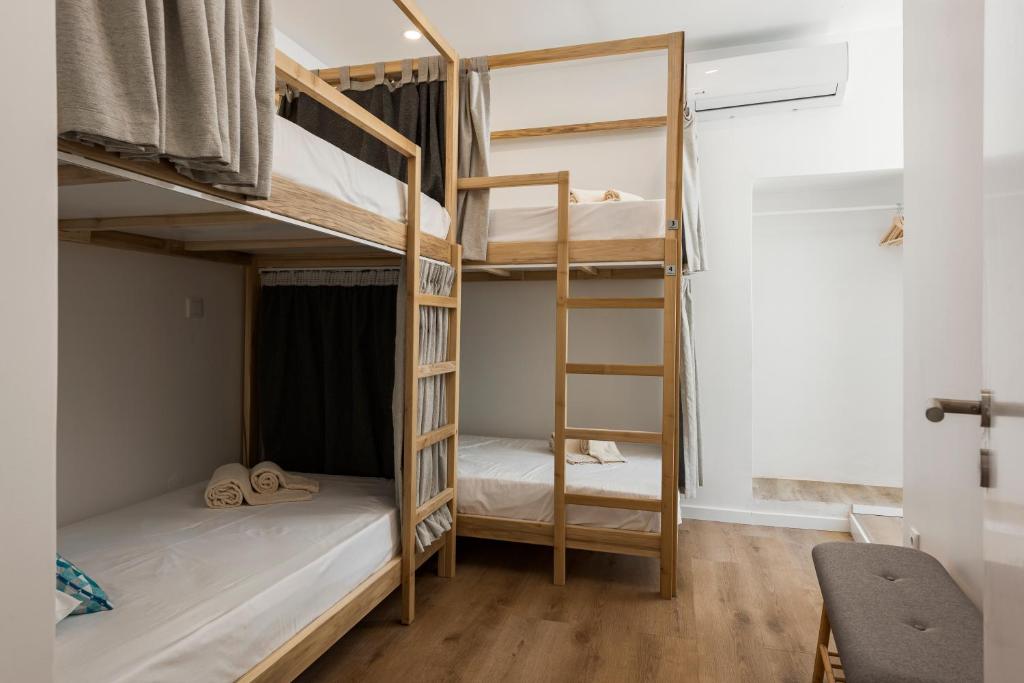 Postel nebo postele na pokoji v ubytování Madalena Hostel e Suites