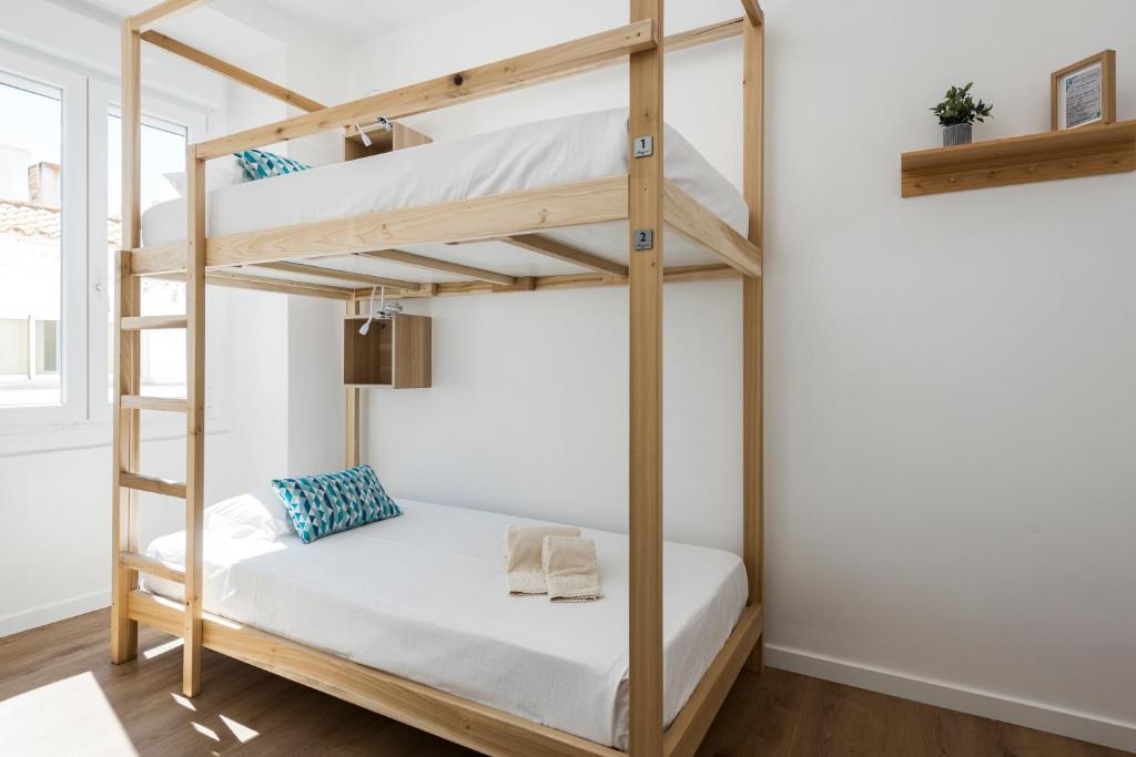 Postel nebo postele na pokoji v ubytování Madalena Hostel e Suites