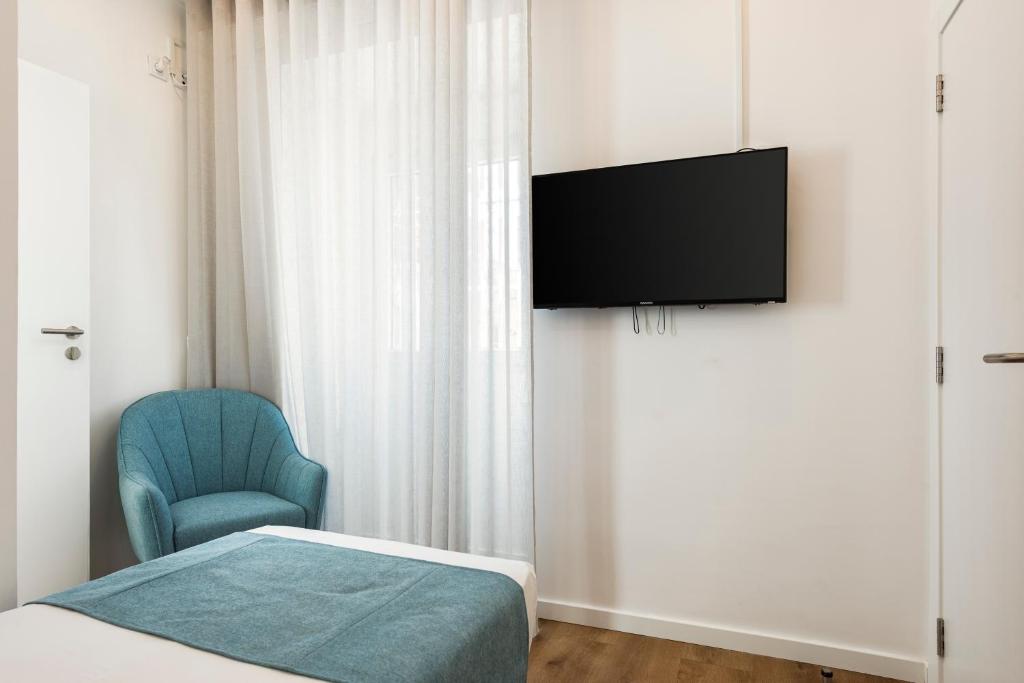 TV a/nebo společenská místnost v ubytování Madalena Hostel e Suites