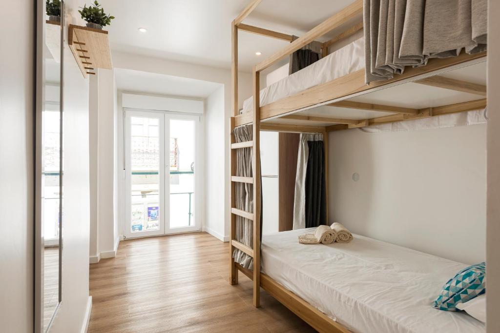 Postel nebo postele na pokoji v ubytování Madalena Hostel e Suites