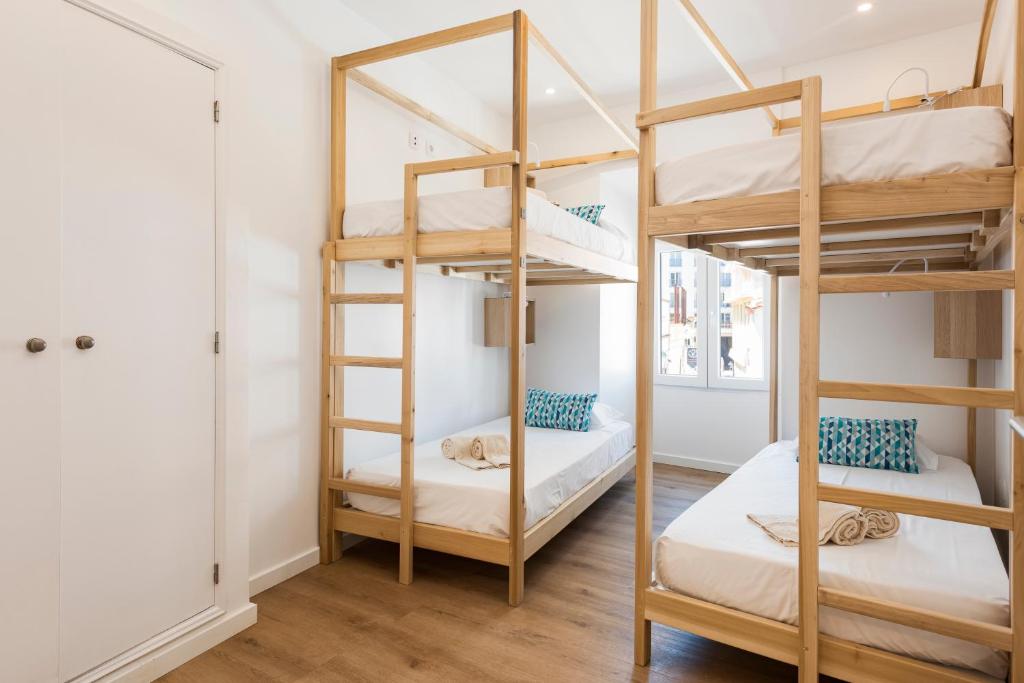 Postel nebo postele na pokoji v ubytování Madalena Hostel e Suites