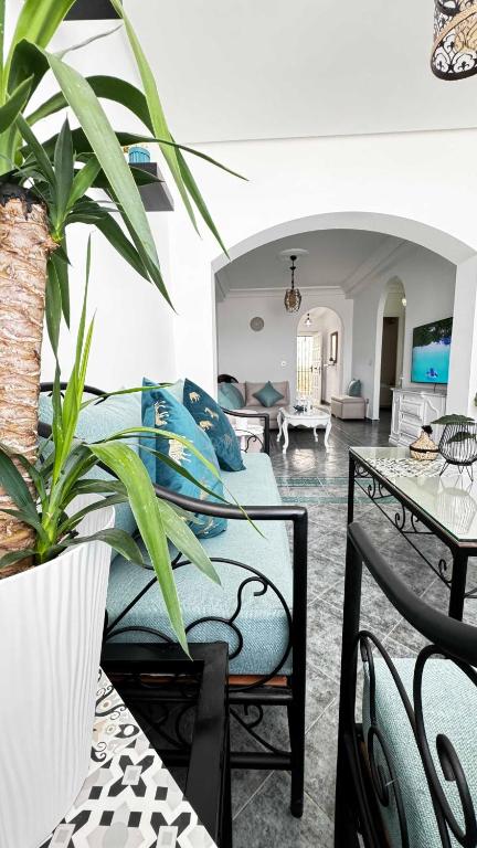 a living room with a couch and a table with a plant at CALAYS Tu hogar junto al mar in Tangier