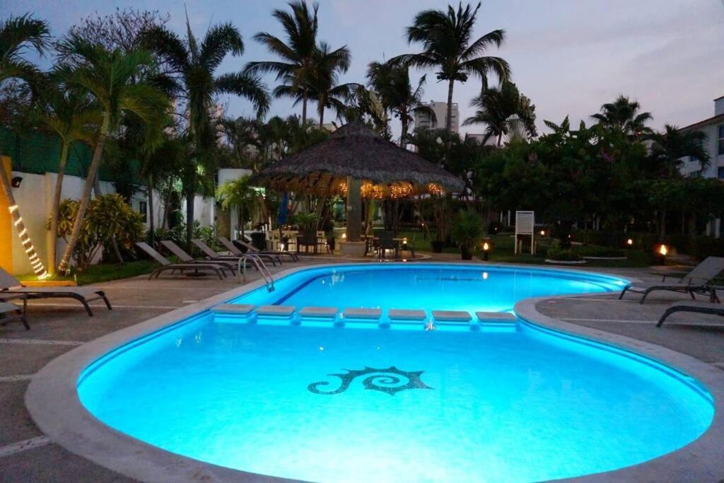 a swimming pool in a resort at night at Beautiful house in secure subdivision in Acapulco