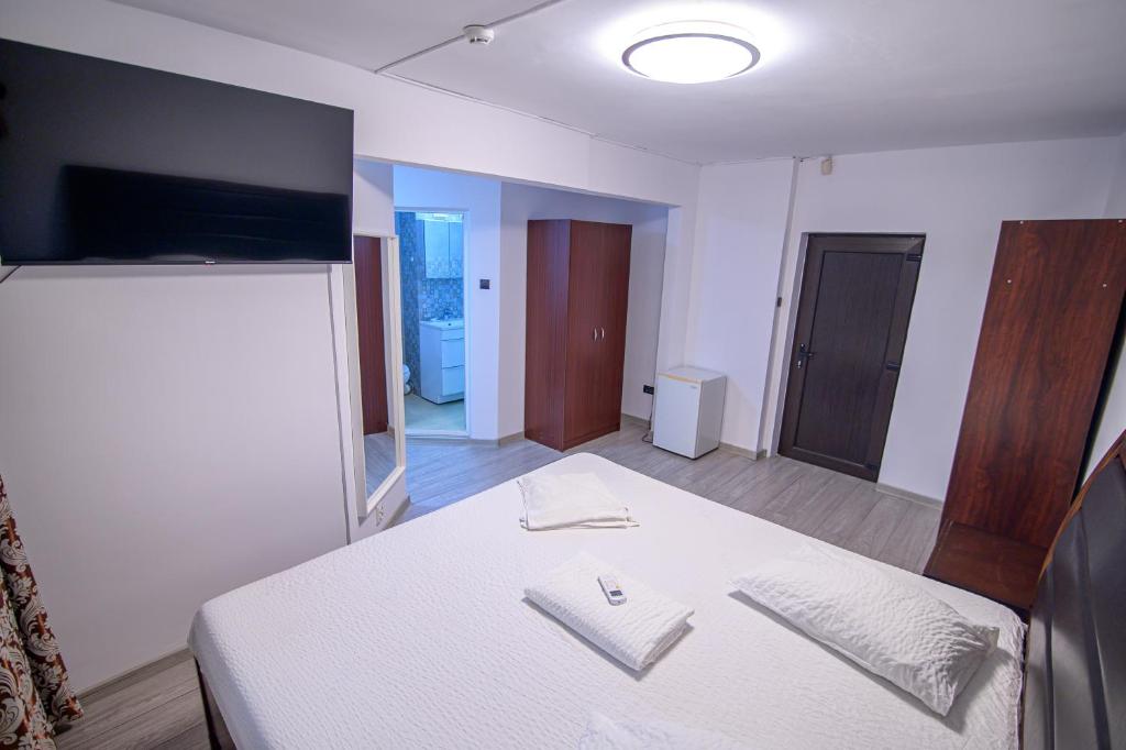 Postel nebo postele na pokoji v ubytování Hotel Proton