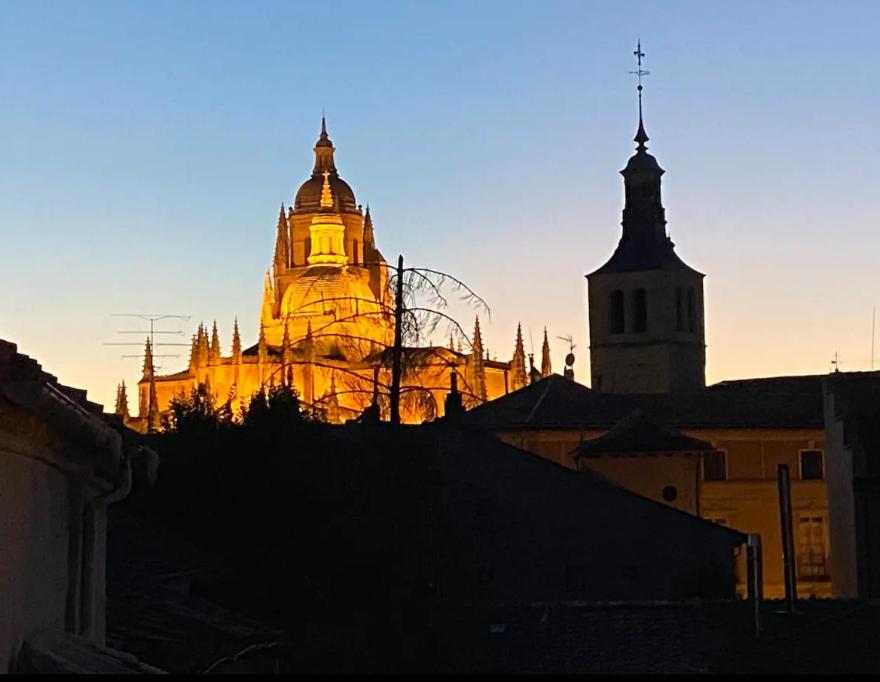 a lit up building with two towers in a city at Sego Apartments I in Segovia