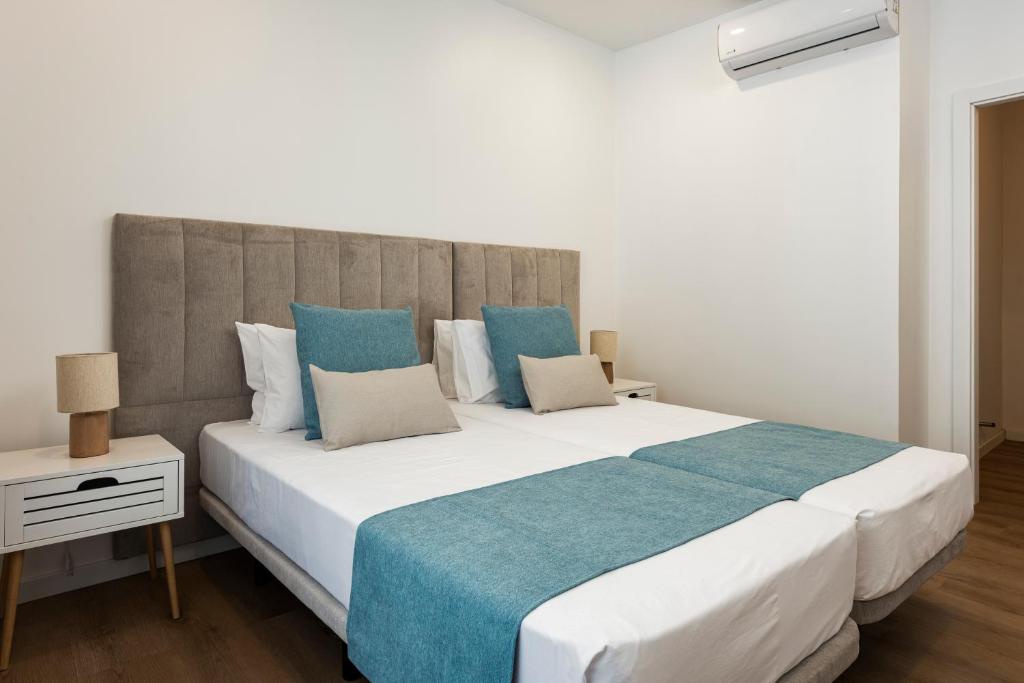 Postel nebo postele na pokoji v ubytování Madalena Hostel e Suites