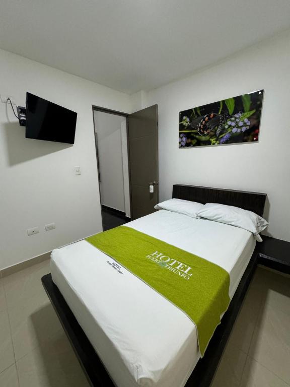 Postel nebo postele na pokoji v ubytování Hotel Puerto Triunfo
