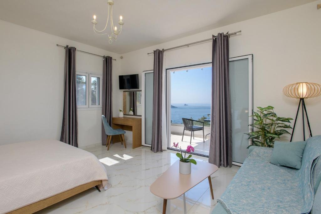 a bedroom with a bed and a view of the ocean at V&D Paleokastritsa Apartments in Lákones